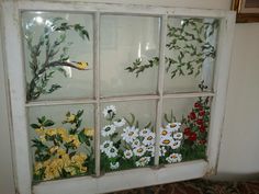 an old window decorated with flowers and birds