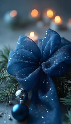 a blue bow on top of a christmas tree