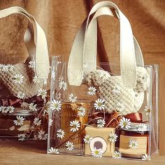 two clear bags filled with different types of items on top of a wooden table next to each other