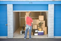 a man standing in the doorway of a storage unit