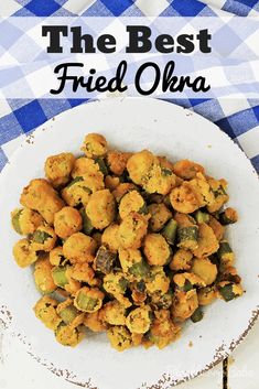 a white plate topped with fried okra next to a blue and white checkered table cloth