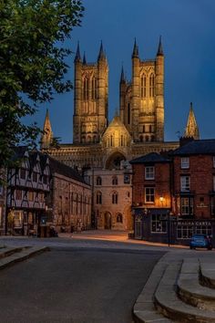 a large cathedral towering over a city at night