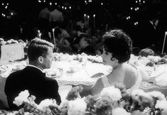 a man and woman sitting at a dinner table