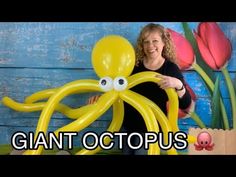 a woman standing next to an octopus balloon