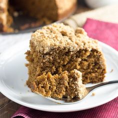 a close up of a piece of cake on a plate with a fork in it