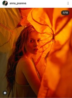 a woman holding an umbrella in front of her face