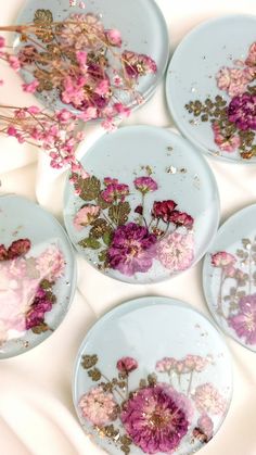 four plates with flowers painted on them