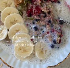 a bowl filled with oatmeal, bananas and berries