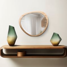 a mirror and some vases on a shelf