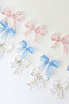 some paper bows are hanging on a string