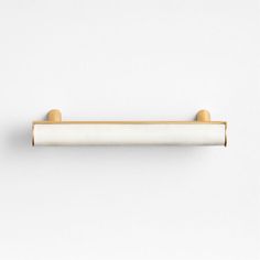 an image of a white and gold towel bar on the wall in front of a white background