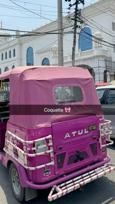 a purple truck is parked on the side of the road