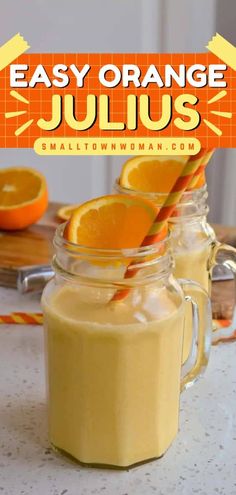 two mason jars filled with orange juice on top of a table next to an orange slice