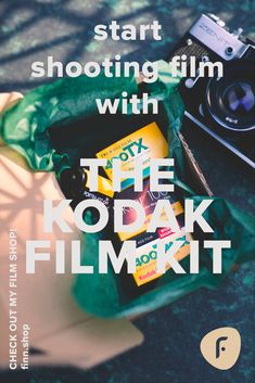 the kodak film kit is sitting next to an old camera