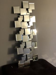 a mirror that is sitting on top of a table in front of a white wall