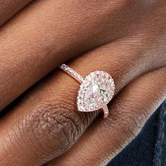 a woman's hand with a diamond ring on it