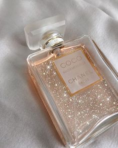 a bottle of chanel coco mademoise eau de toilette on a white cloth