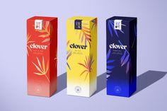 three boxes with different flavors on them sitting side by side in front of a purple background