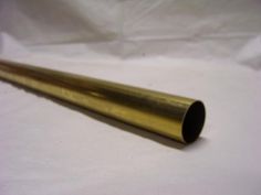 a brass tube on a white background