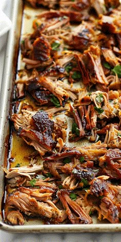 a baking pan filled with pulled pork and barbecue sauce