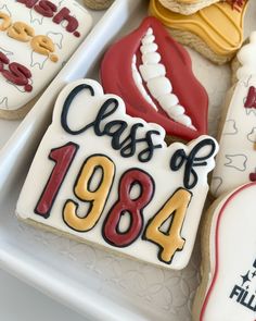 decorated cookies in the shape of mouths and teeth are on a platter with writing that reads class of 1934