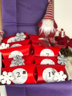 red boxes with numbers and snowflakes are sitting in front of a purple chair