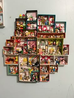 a bunch of toys that are on the wall in front of a white wall and some shelves