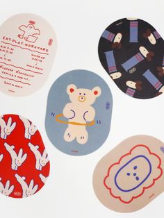 four circular stickers with various designs on them, all in different colors and shapes