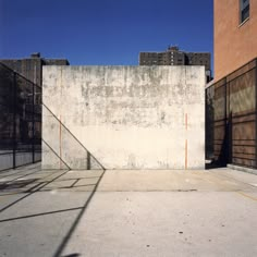 an empty parking lot next to tall buildings