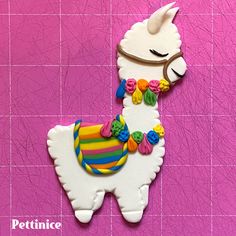 a cookie shaped like a llama with buttons on it's back and neck