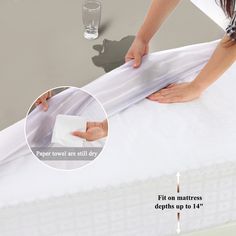 a woman is wrapping up a mattress with white sheets and water on the bottom edge