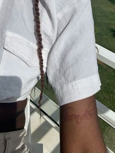 a person with long braids standing on a balcony