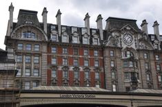 an old building with a clock on the front