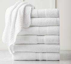 a stack of white towels folded on top of each other