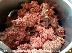 ground meat in a metal bowl with a spoon