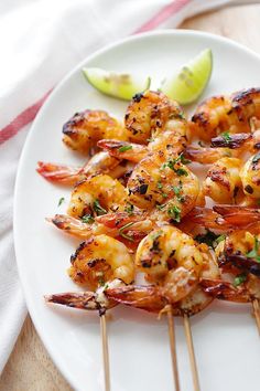 grilled shrimp skewers on a white plate