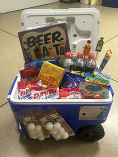 a cooler filled with drinks and snacks on the floor