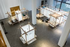 an aerial view of the inside of a building with several wooden structures on display in front of large windows