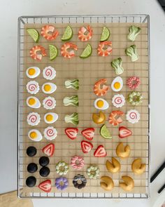 an assortment of cookies and pastries on a cooling rack with chopsticks next to them