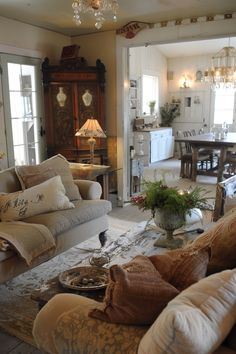 a living room filled with furniture and a chandelier