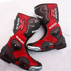 two red and black boots with silver accents on them, one has the word suzuki written on it