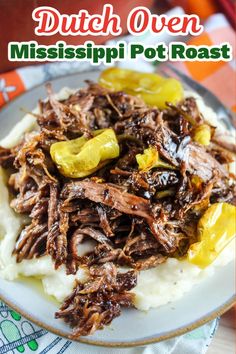 a white plate topped with meat and mashed potatoes