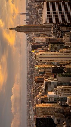 an aerial view of new york city with clouds in the sky and skyscrapers on either side