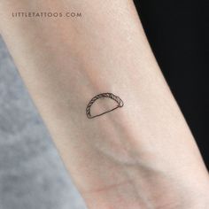 a small taco tattoo on the wrist that looks like it has been placed on someone's arm