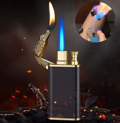 a lighter that is lit up with blue flame and gold trimmings on it