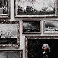 a wall with many paintings on it that include ships and men's boats,