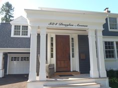 the front entrance to a home with white pillars