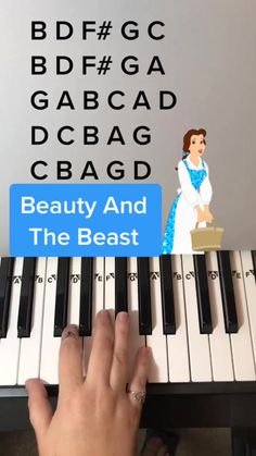 someone is playing piano with the words beauty and the beast on it's keyboard