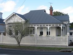 an old house with a white picket fence