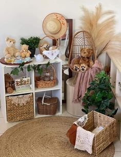 there are many stuffed animals in baskets on the floor next to some plants and bookshelves